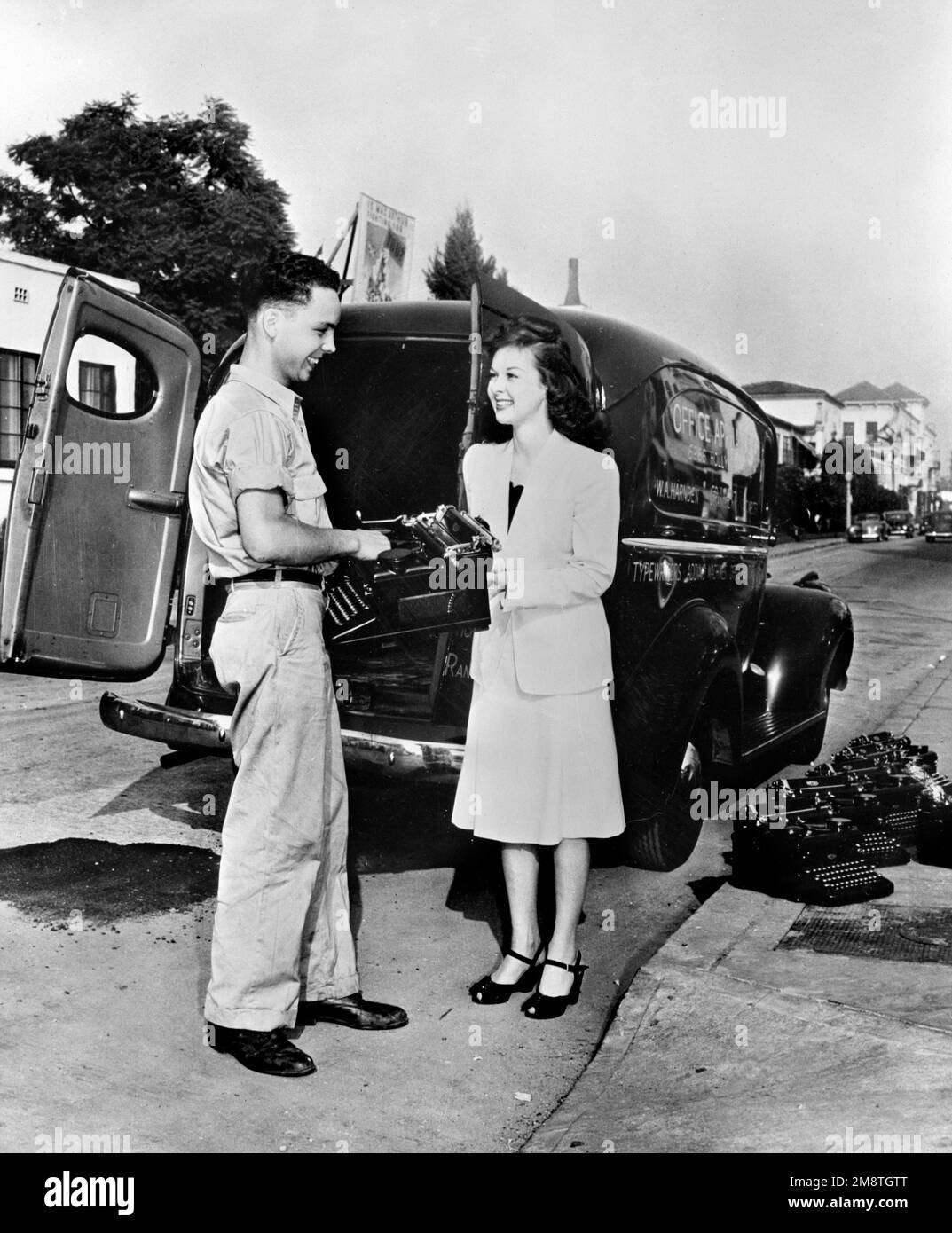 Susan Hayward. Photograph entitled 'Paramount Picture star sends her typewriter to war. Susan Hayward, Paramount motion picture star, does her share in sending typewriters to war. Pictures shows Miss Hayward selling her machine to the government as her contribution to the typewriter campaign. Uncle Sam needs 600,000 typewriters for the armed services and is contracting all possible typewriter users to urge them to release '1 out of 4' typewriters for Army and Navy service.' 1942 Stock Photo