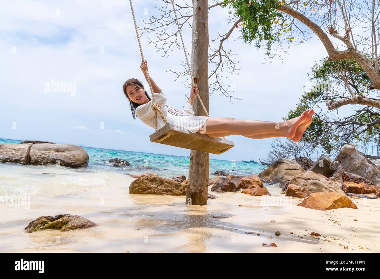 Happy young woman on the beach Stock Photo - Alamy