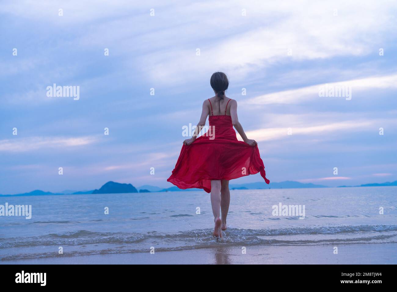 Happy young woman on the beach Stock Photo - Alamy