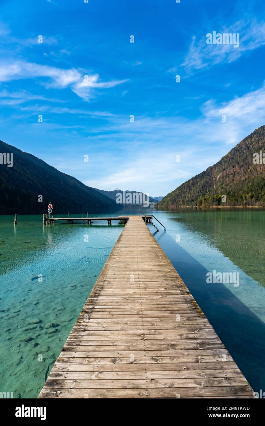 Lake Weissensee in Carinthia. Jetty at the east riverbank close to Stockenboi during autumn. Stock Photo