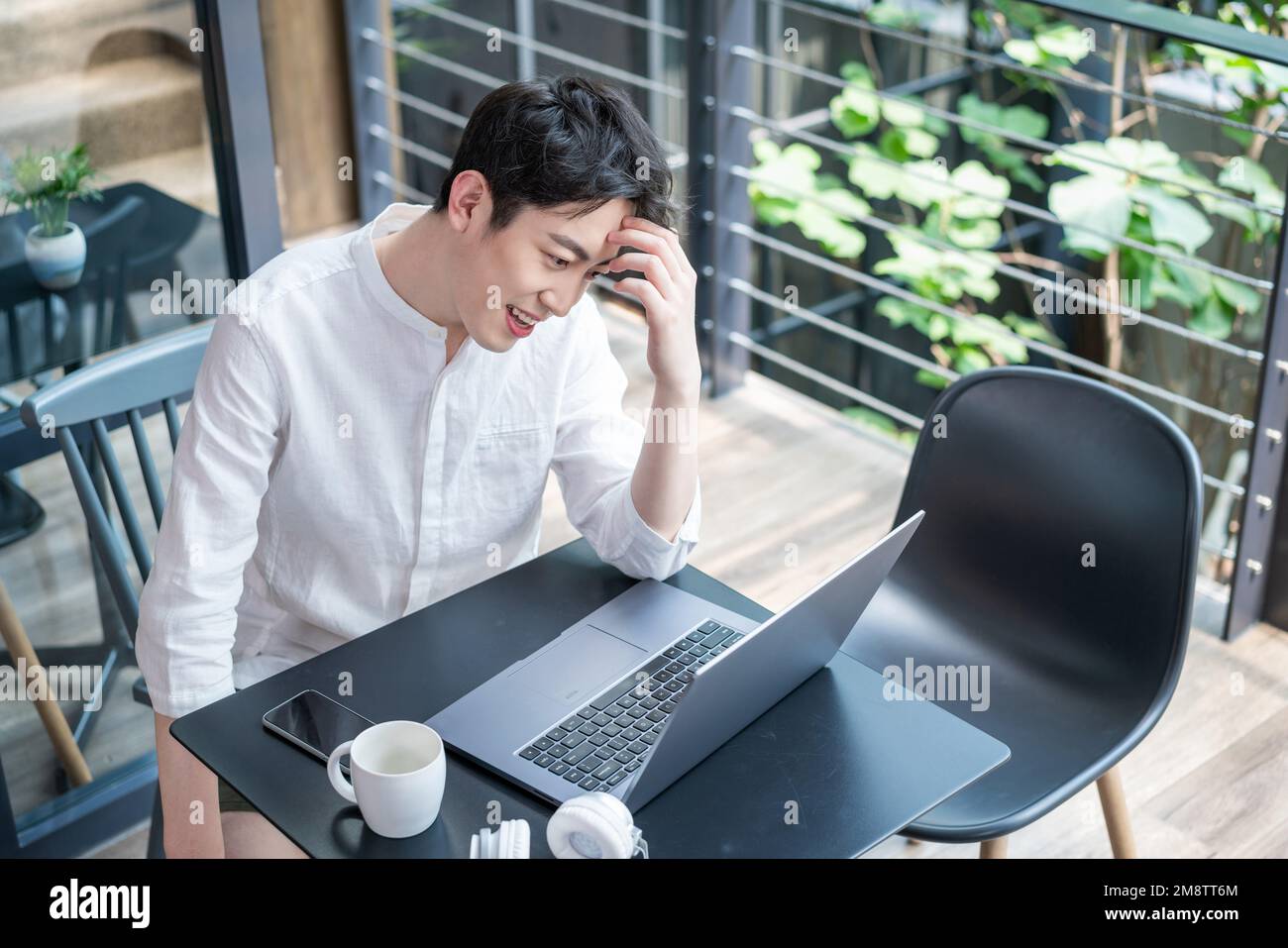 Young men who use a computer Stock Photo - Alamy