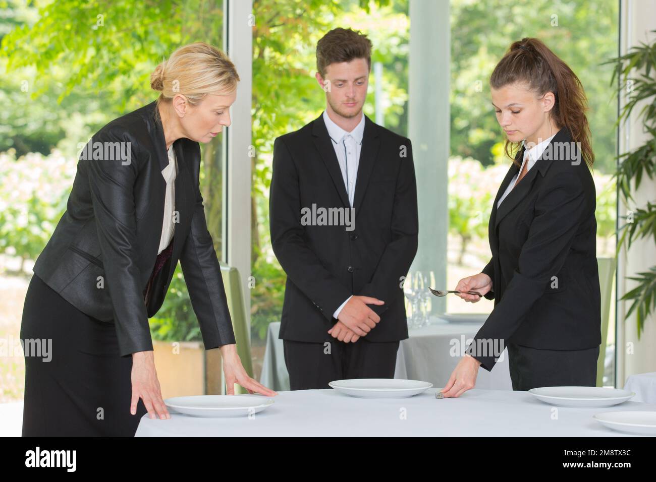 manager training restaurant students in salon Stock Photo