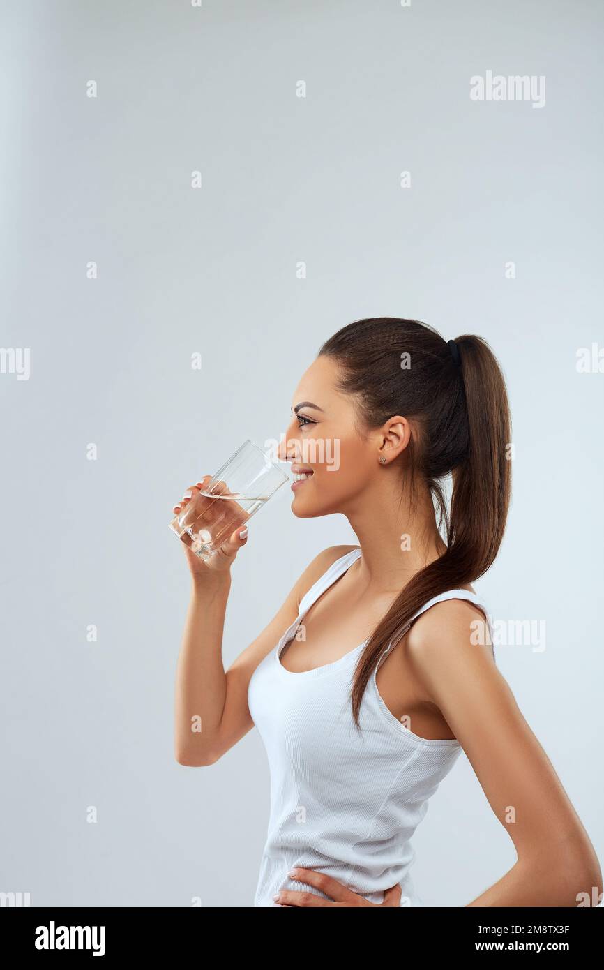 Drink Water. Portrait Of Beautiful Healthy Girl Drinking Fresh Water. Young Woman With Glass Of Water. Diet Concept Stock Photo