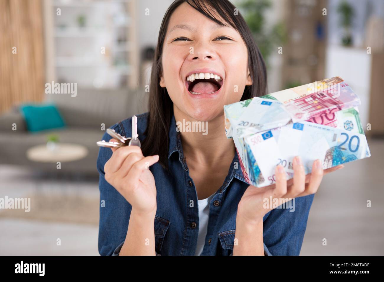 young smiling girl holding keys from house Stock Photo - Alamy