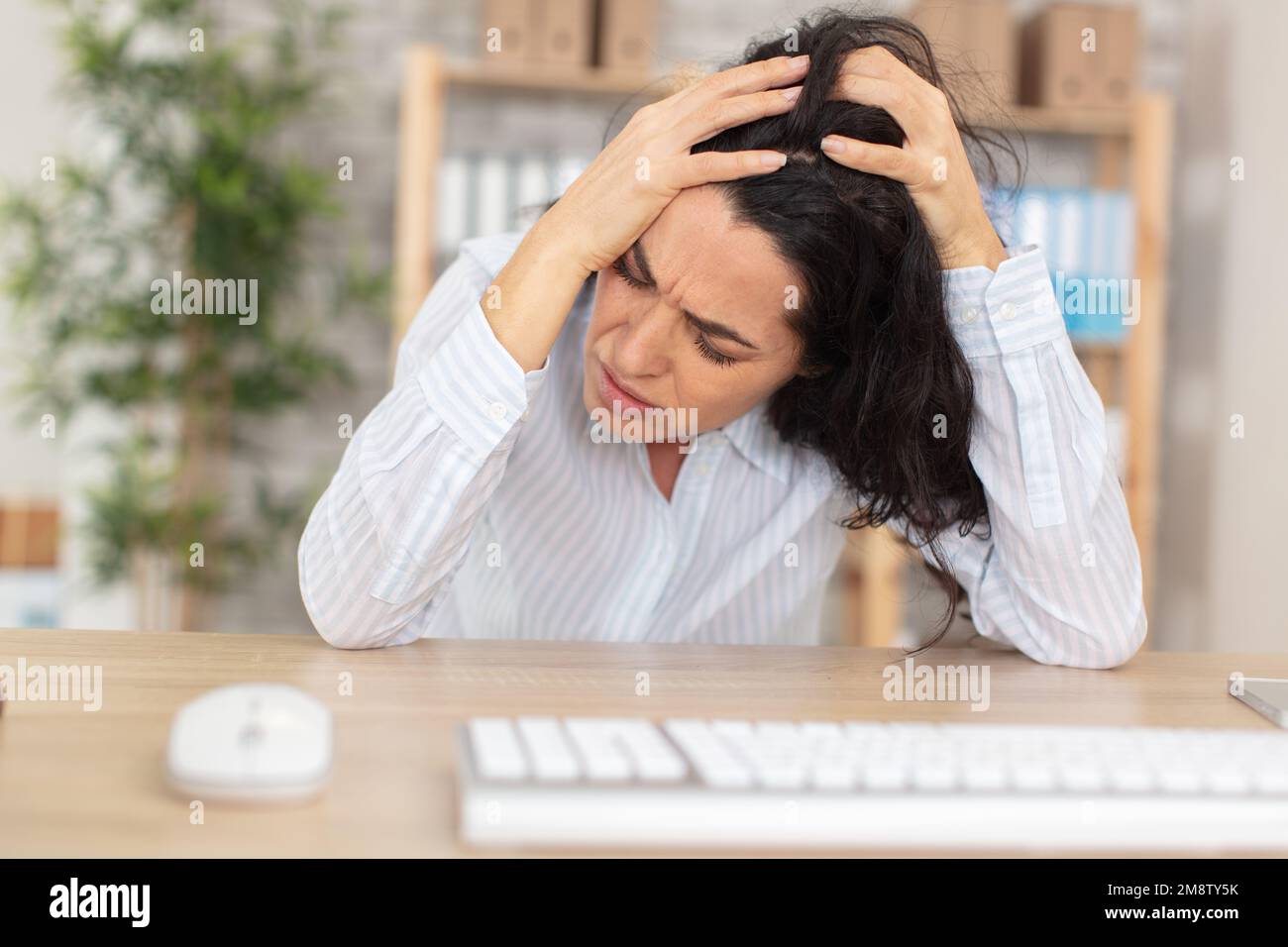 business woman with headache at office Stock Photo