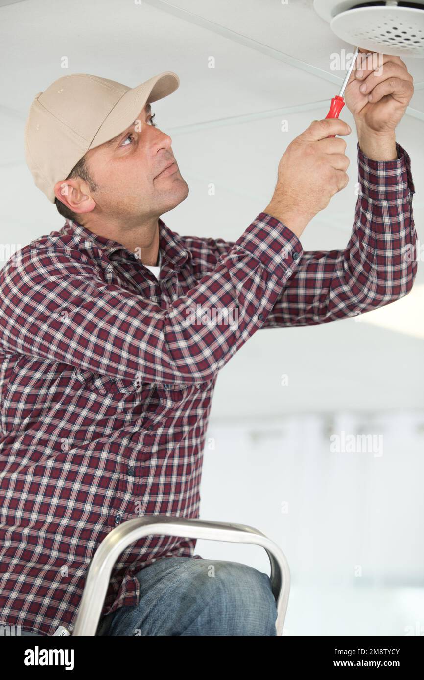 a man changing light bulb Stock Photo Alamy