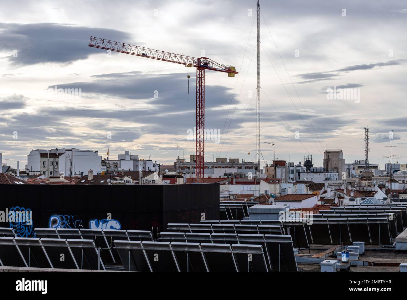 Crane and Solar panels in a roof in Madrid, Spain Stock Photo
