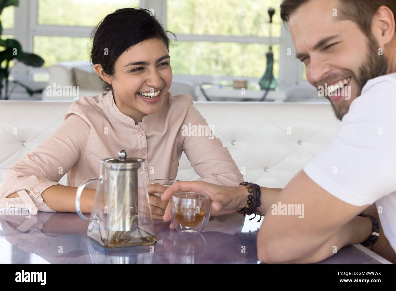 Cheerful pretty young Indian woman and handsome guy having fun Stock Photo