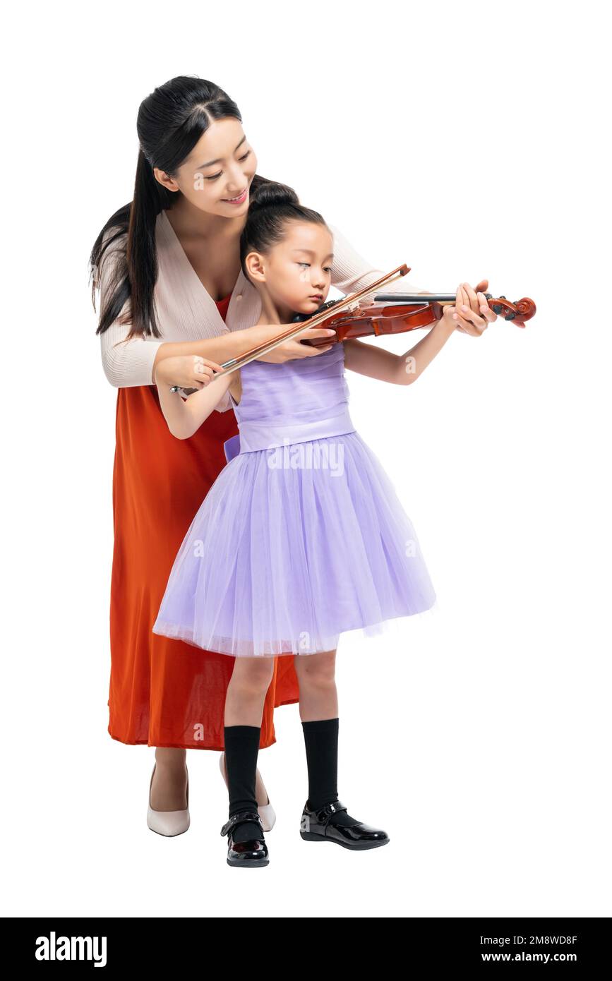 The female teacher guide girl playing Musical Instruments Stock Photo