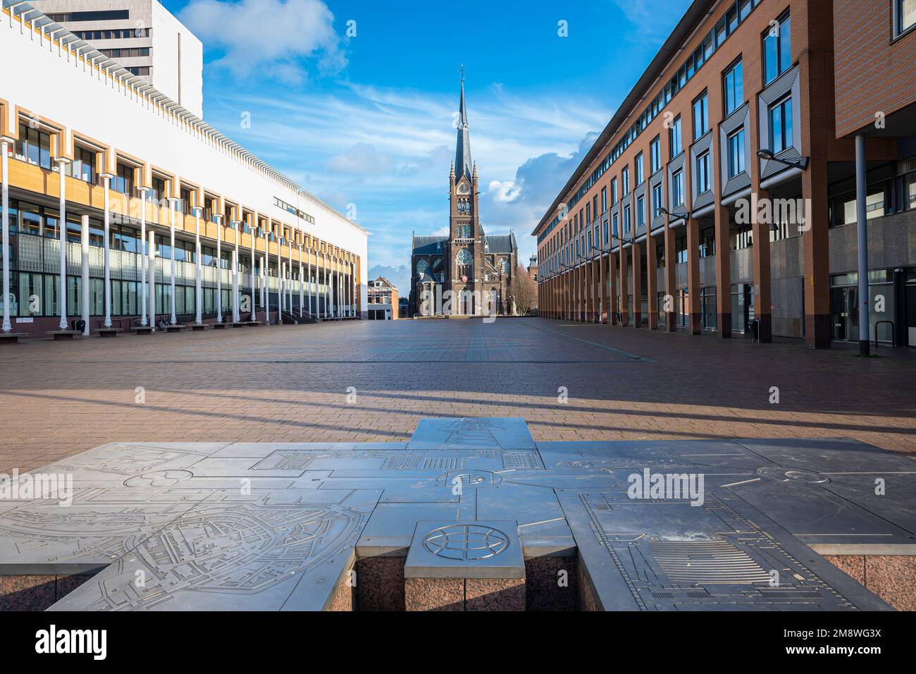New town square with modern theater and stores.In middle the historic Catholic church 'Liduina Basilica' in the historic town of Schiedam, Holland. Stock Photo