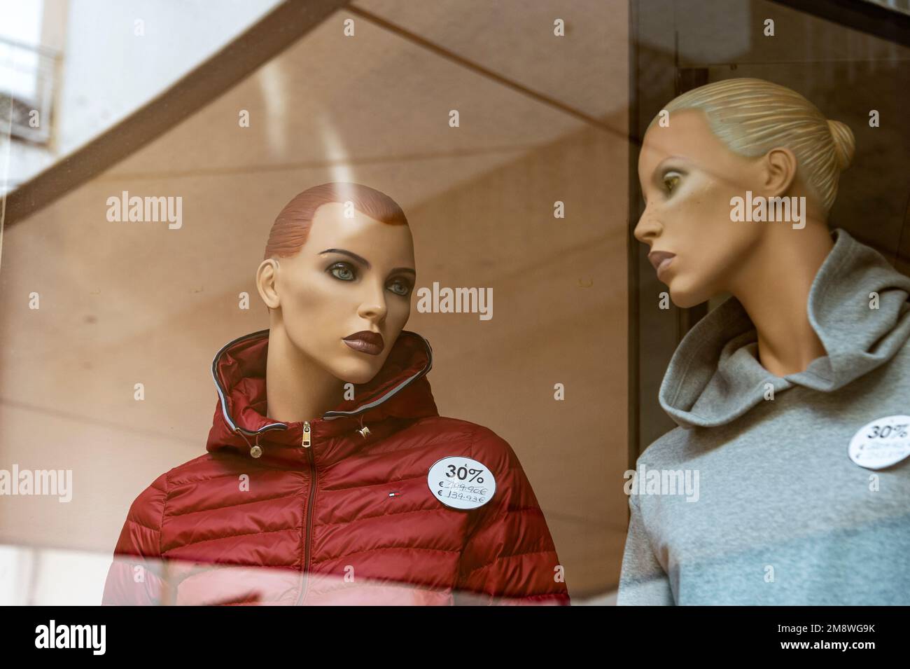 Two female mannequins on display in a clothing shop window Stock Photo