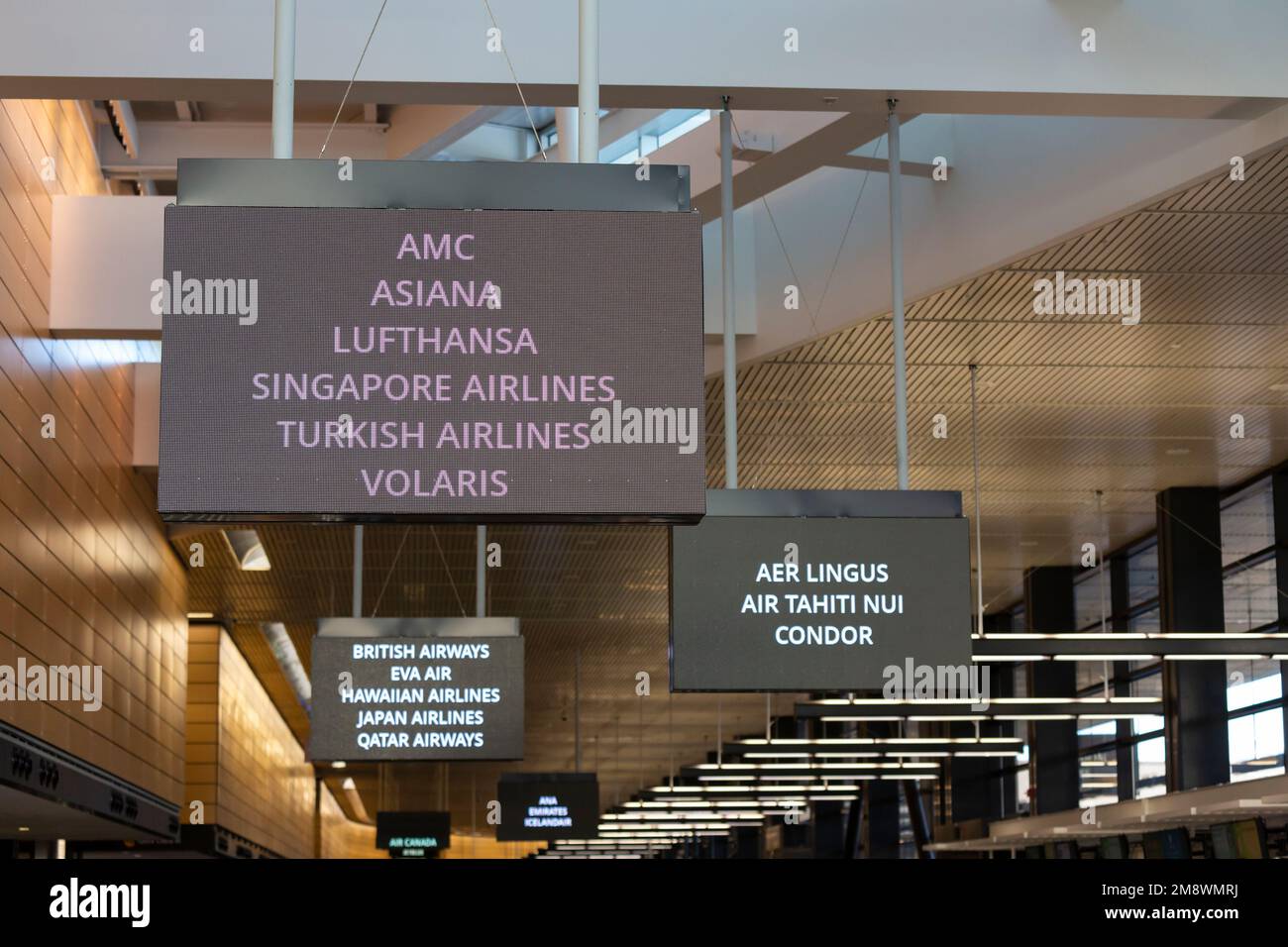 Signs direct passengers to various airlines ticket counter areas at