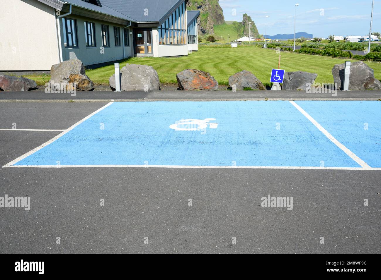 Parking space for disabled in a public parking on a sunny day Stock Photo