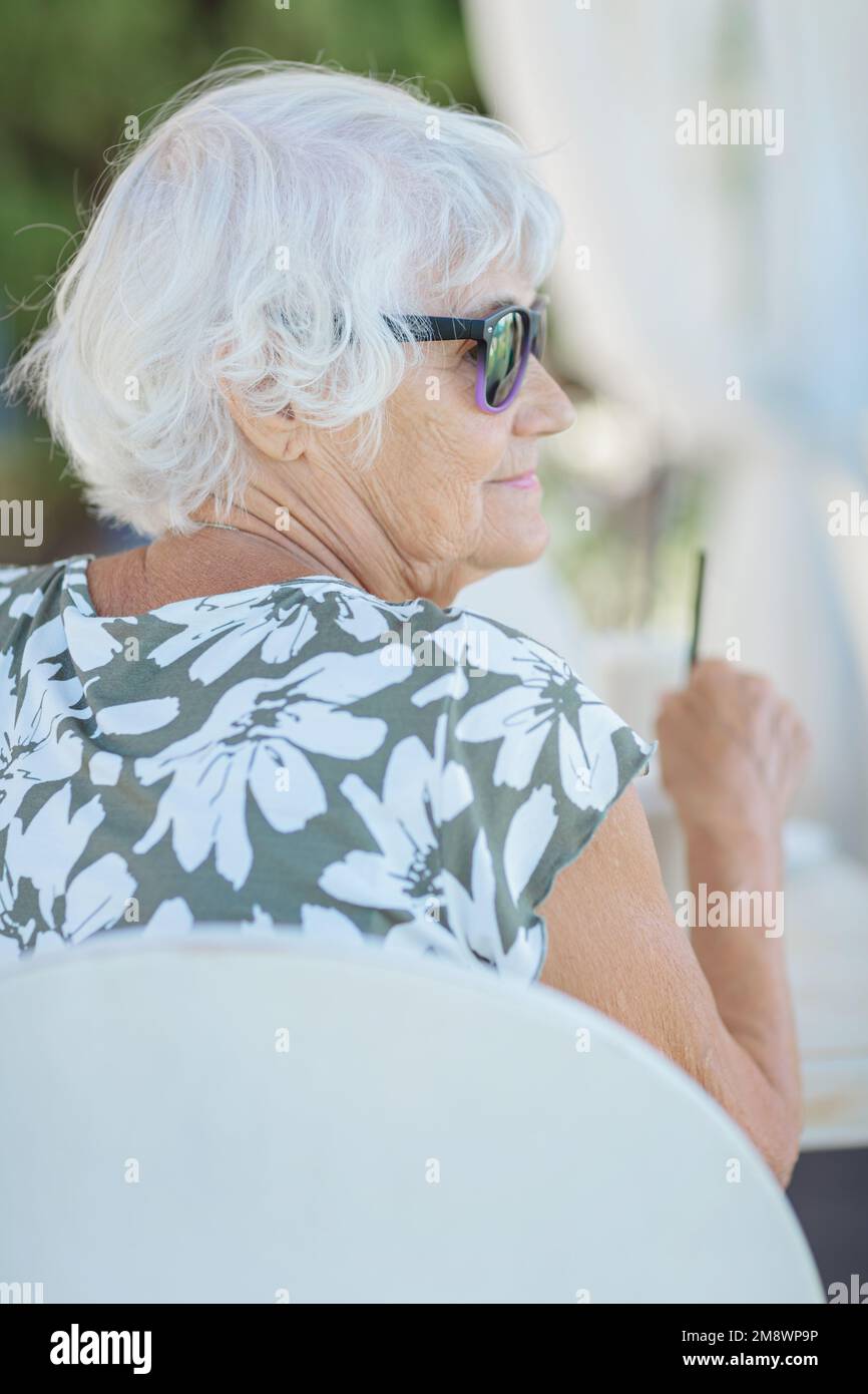 Mature woman alone sitting garden hi-res stock photography and images ...