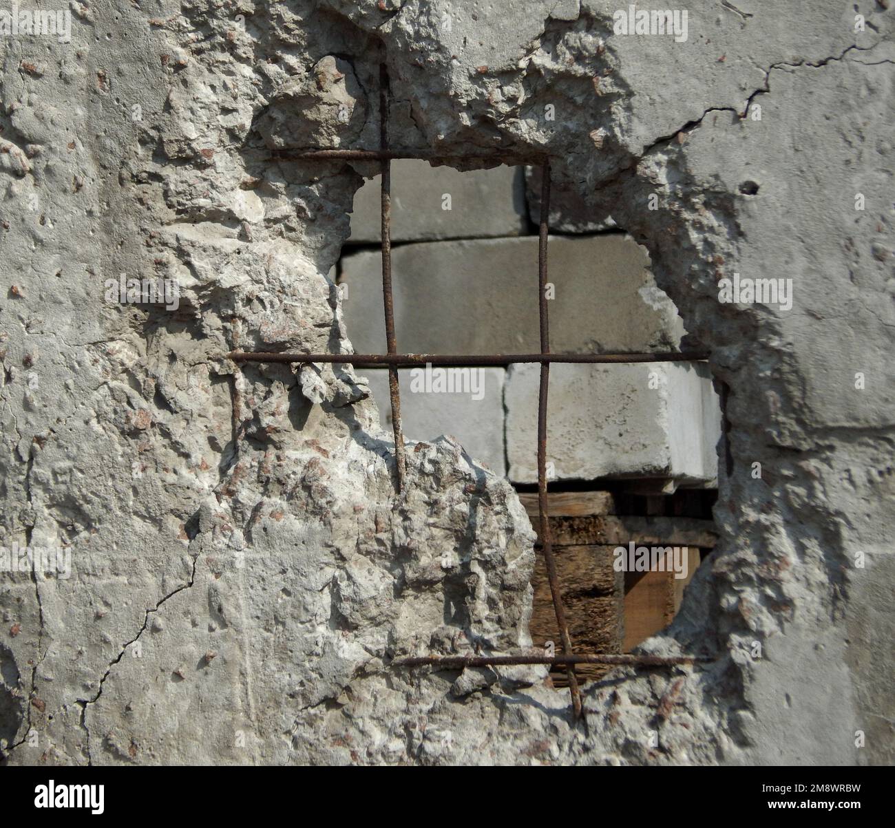 Hole In Damaged Concrete Wall By A Rocket Hit Stock Photo