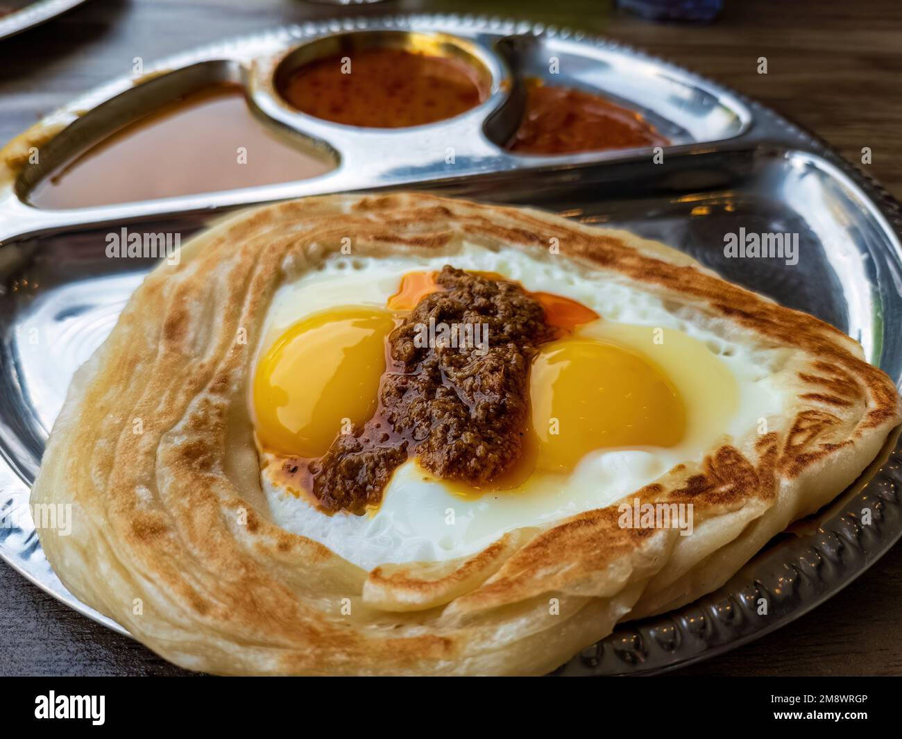 a Roti sarang burung served with different gravies Stock Photo