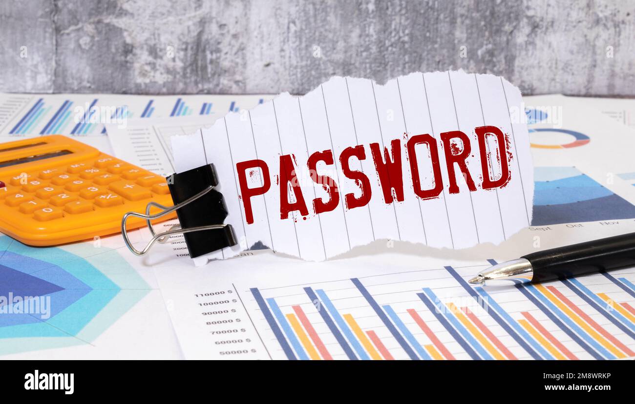 The word password written on a sticky note paper on computer keyboard. Password management or internet cyber security concept. Stock Photo