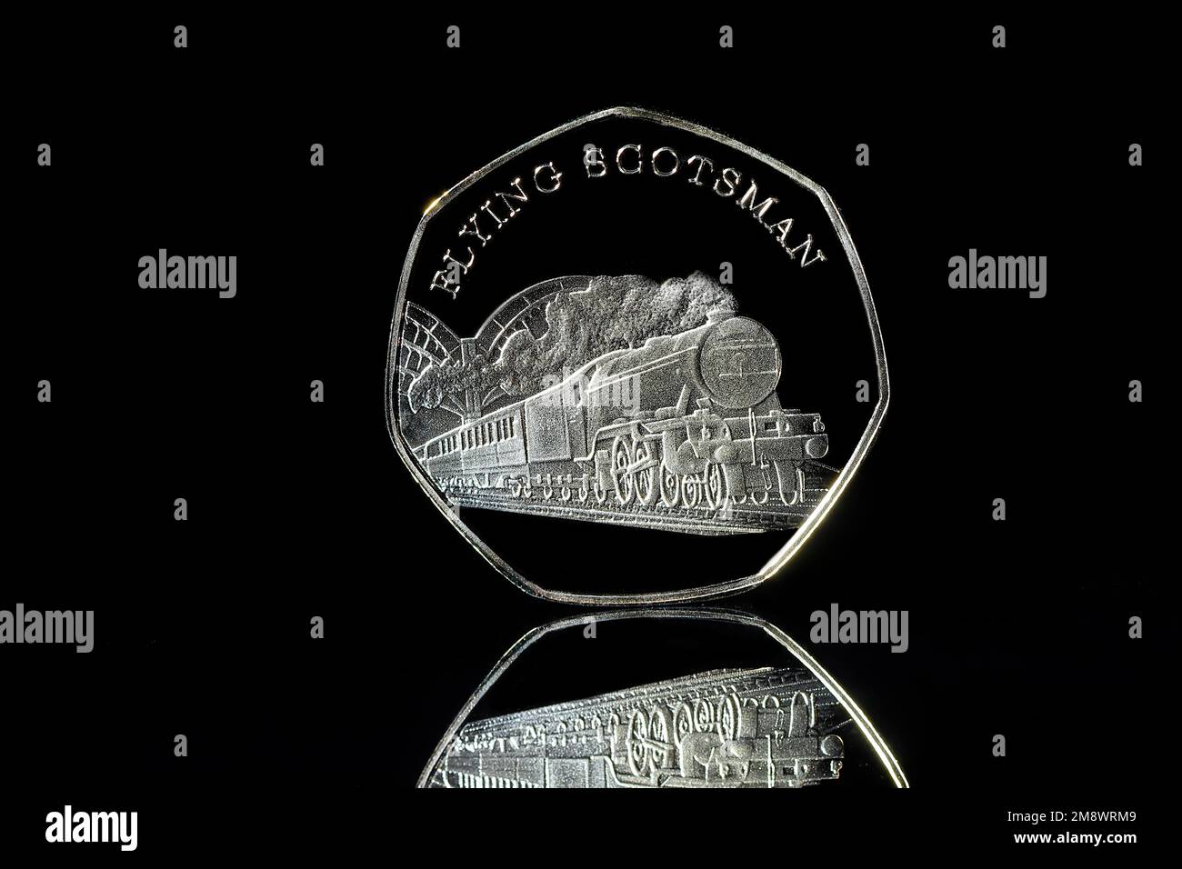 A Gold 50p coin featuring the Flying Scotsman which is not legal tender