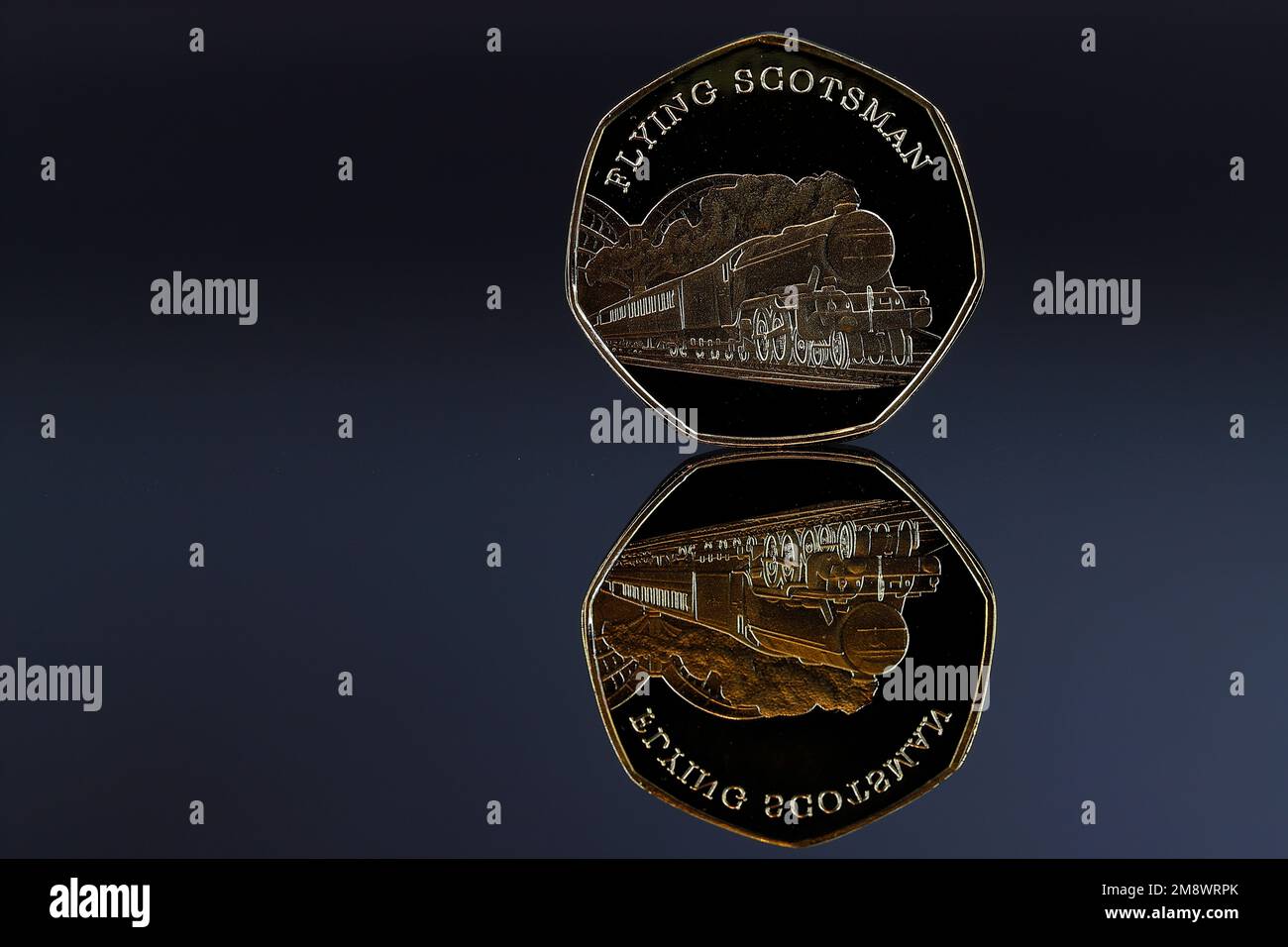 A Gold 50p coin featuring the Flying Scotsman which is not legal tender