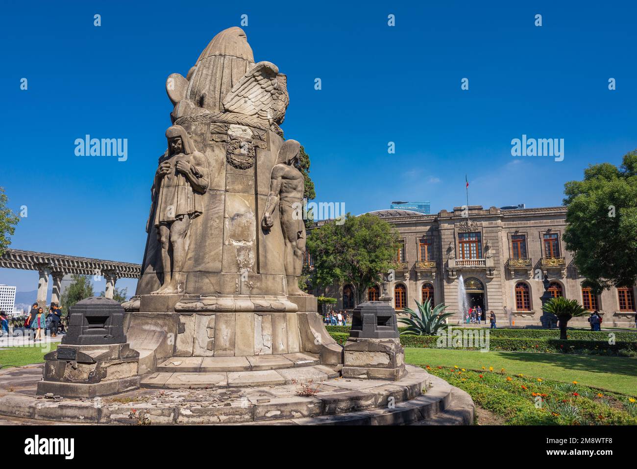 Departure from the National Museum of Chapultepec in the castle with a group of tourists leaving the garden with sculptures and water fountains Stock Photo