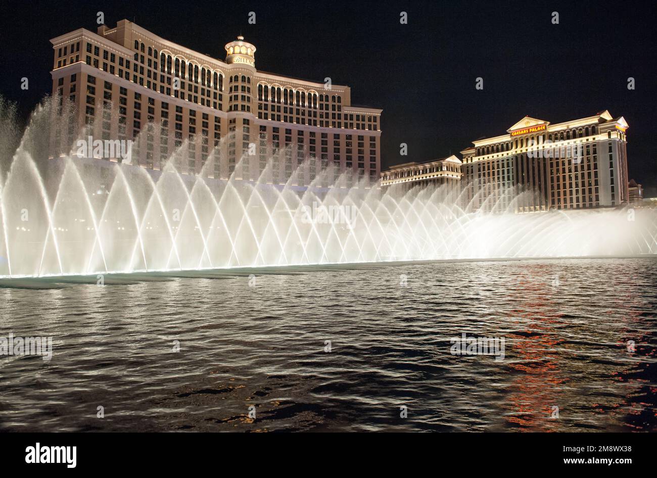 Bellagio Fountains and Caesars Palace on Las Vegas Strip by night Stock Photo