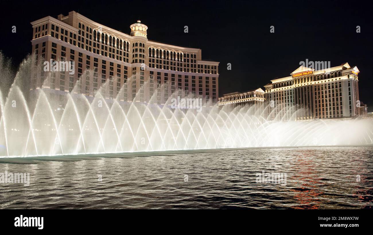 Bellagio Fountains and Caesars Palace on Las Vegas Strip by night Stock Photo