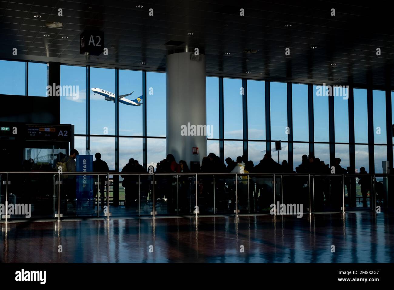 Bergamo (Italy), Jan. 9, 2023: Passengers queuing at a boarding gate at the Caravaggio International Airport, better known as Bergamo Orio al Serio. Stock Photo