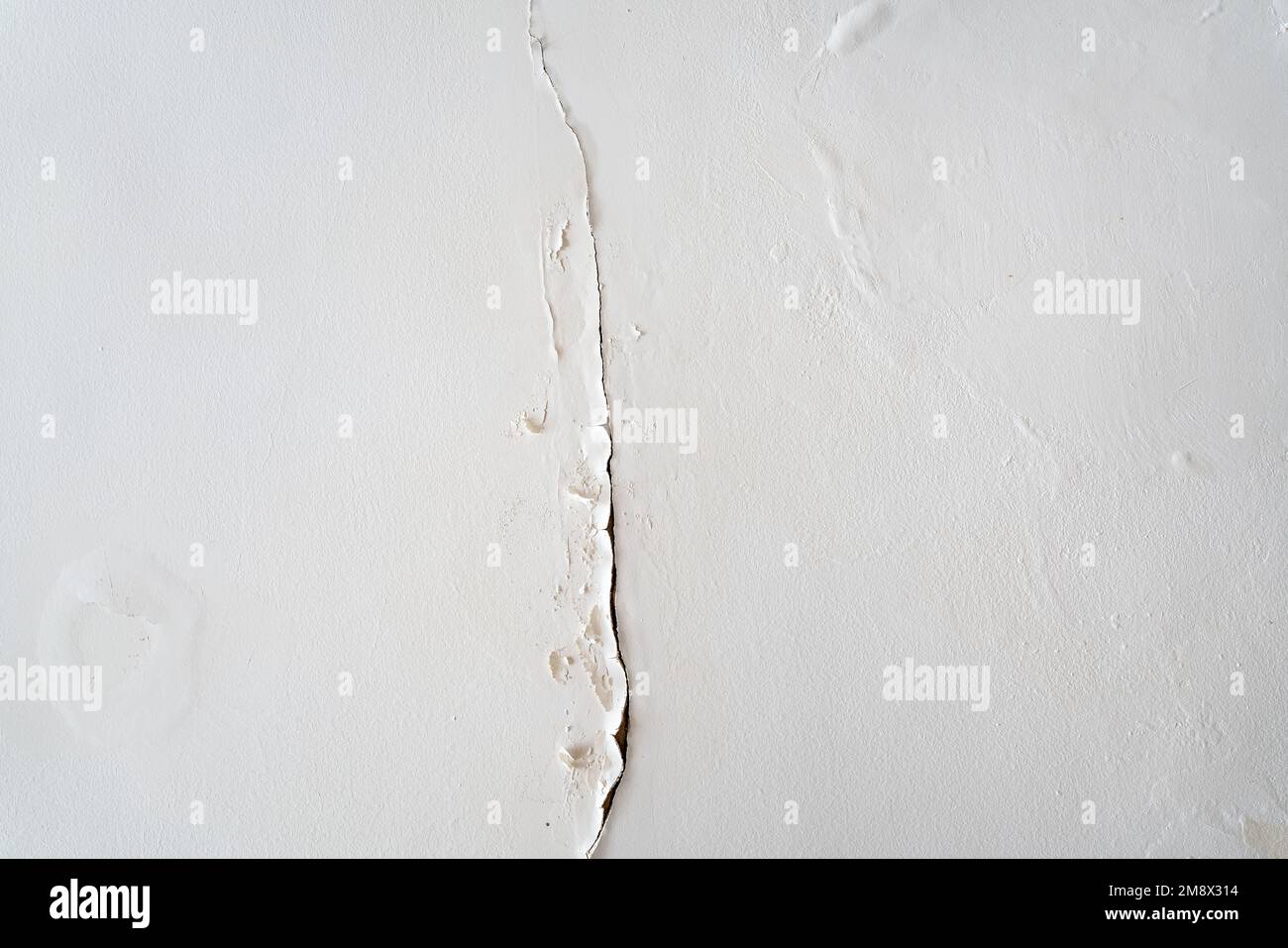 View of a roof and a crack with rain water seeping into the wall
