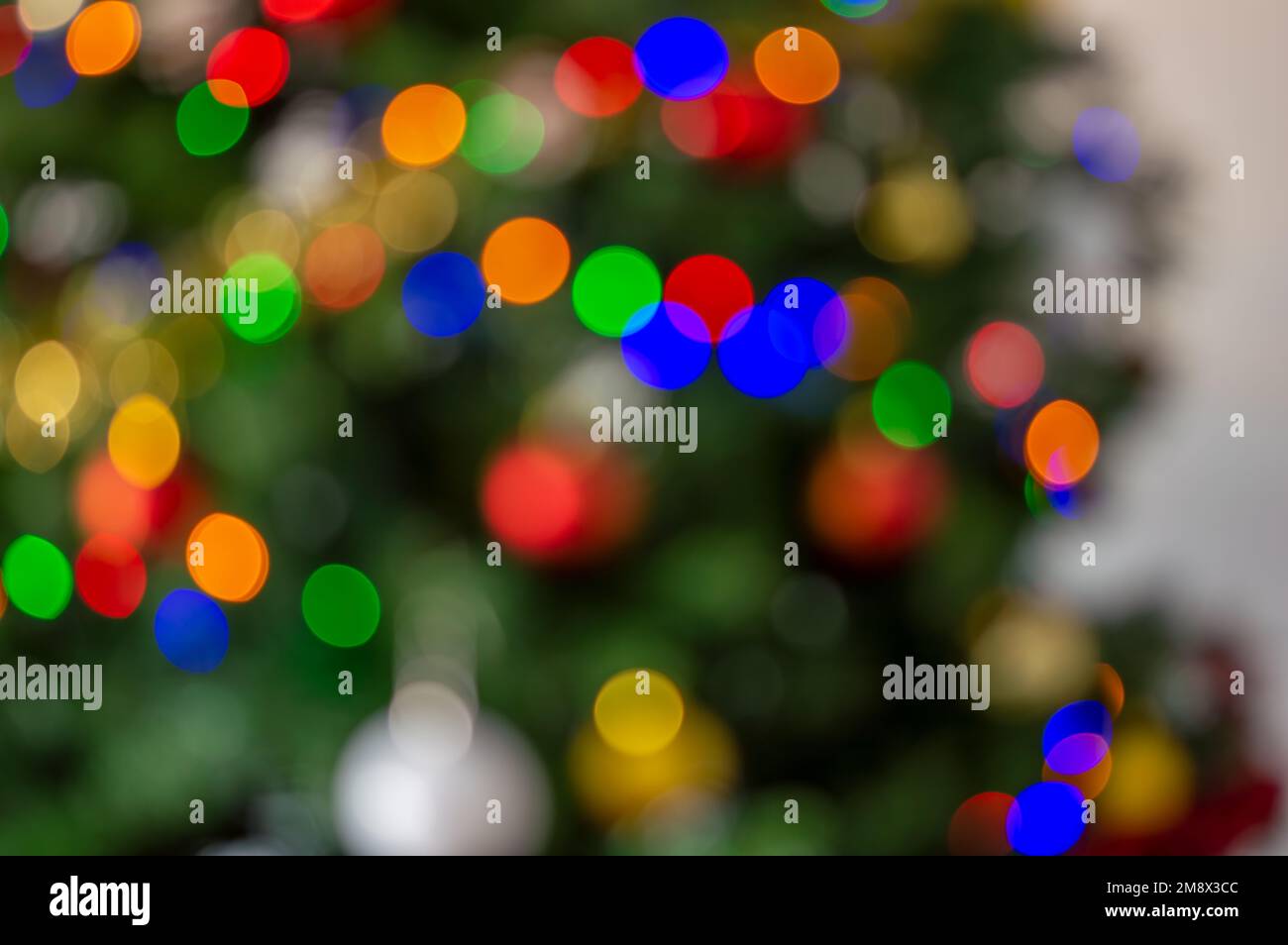 Bright lights on a Christmas tree. Defocused shot of a beautifully decorated Christmas tree Stock Photo