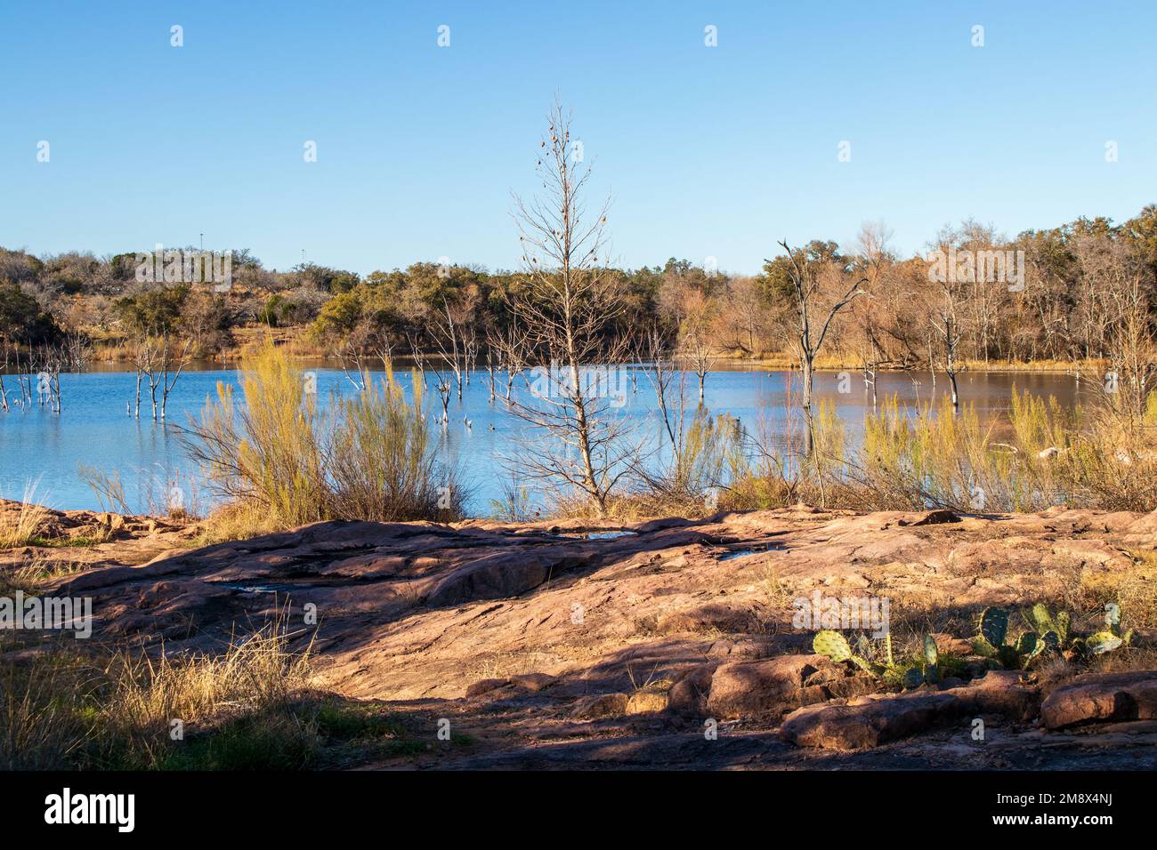 Texas Hill Country hiking trail with a view of Inks Lake. The sunset