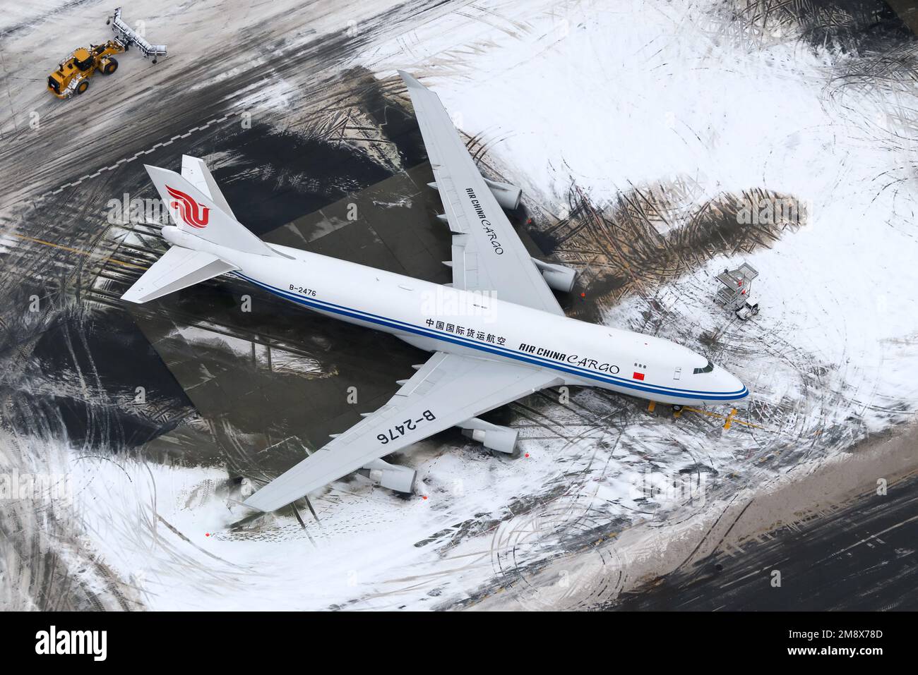Air China cargo Boeing 747-400 aircraft parked at Anchorage Airport after snow storm. Airplane 747-400F of Air China Cargo after with snow around. Stock Photo