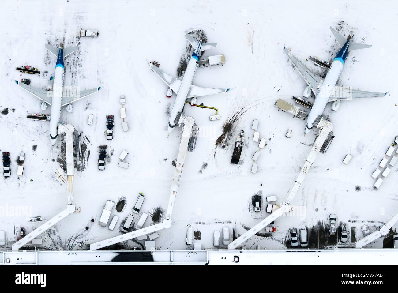 Alaska Airlines operations at Anchorage Airport after a heavy snow fall. Aviation in winter with snow. Aircraft Boeing 737 and Embraer of Alaska. Stock Photo