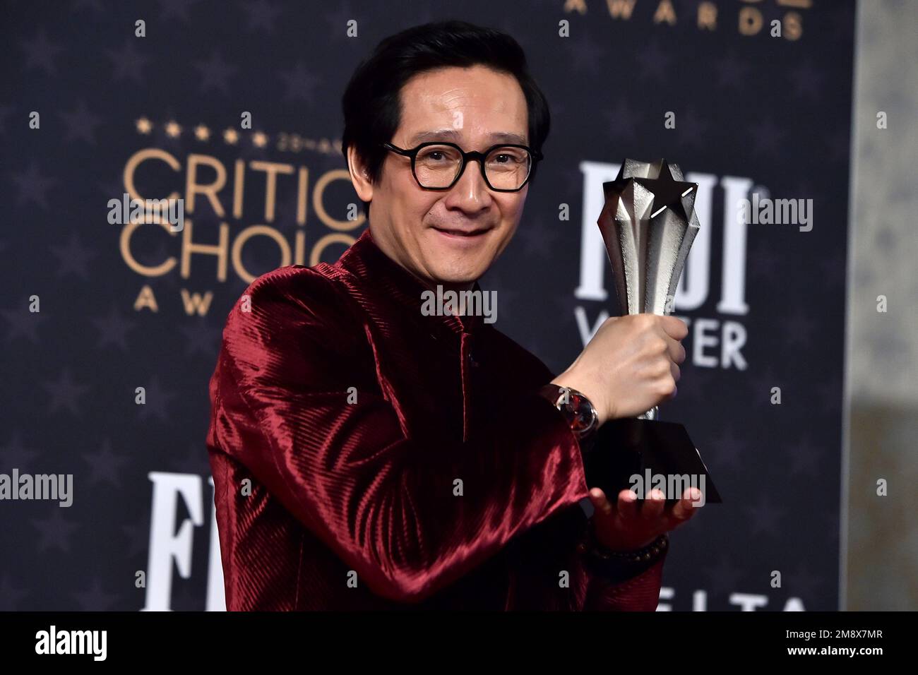 Ke Huy Quan poses in the press room with the award for best supporting ...