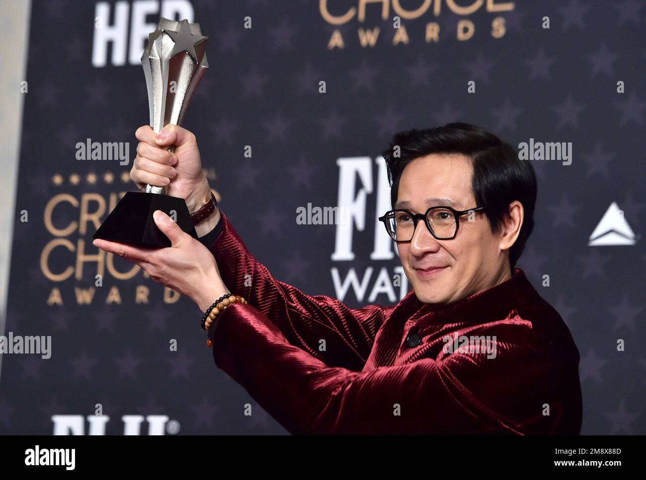 Ke Huy Quan poses with the award for best supporting actor for