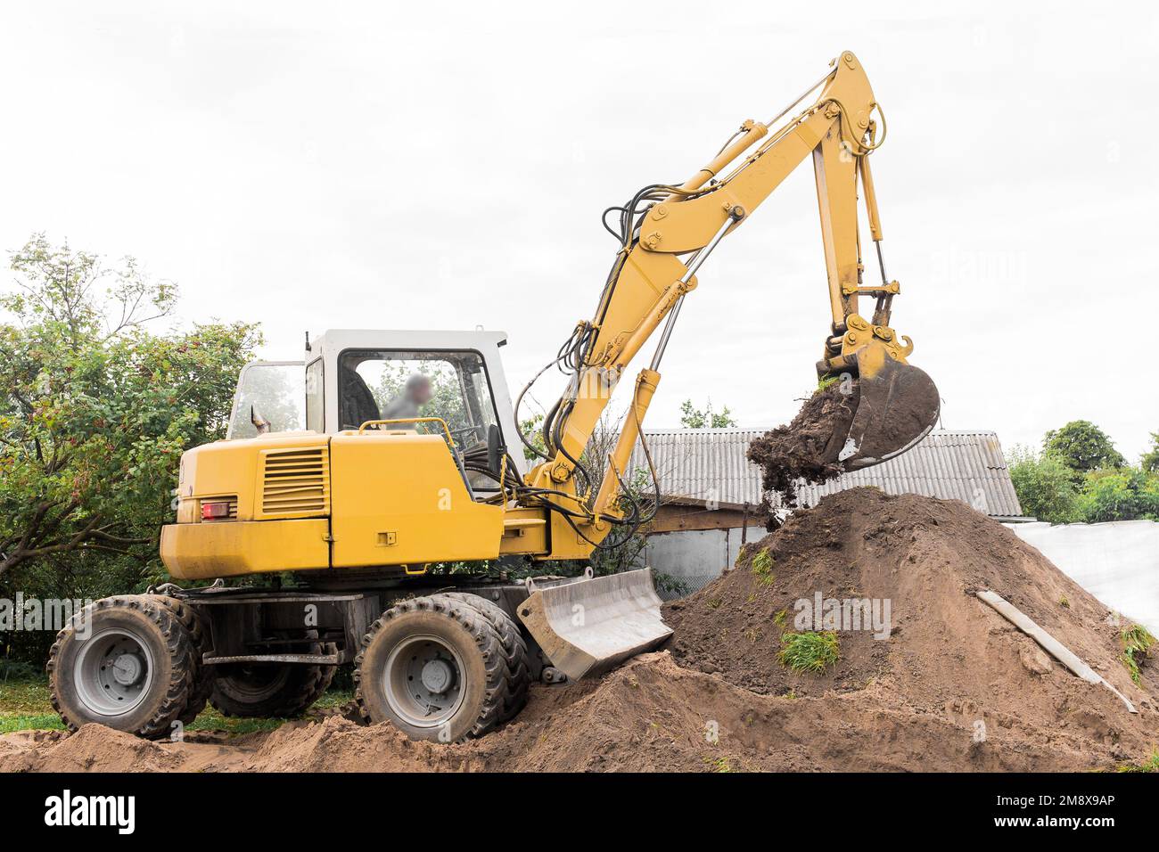 A excavator is digging on outdoors in an industrial site. Excavation works. Stock Photo