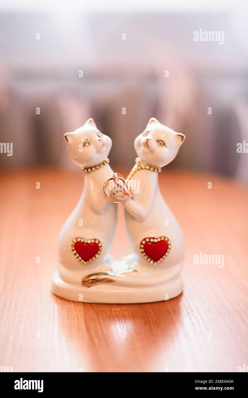 two Golden wedding traditional rings on the figurines with cats Stock