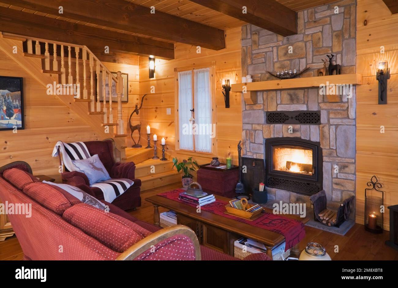 Burgundy with white polkadot upholstered sofa, armchair with throw and