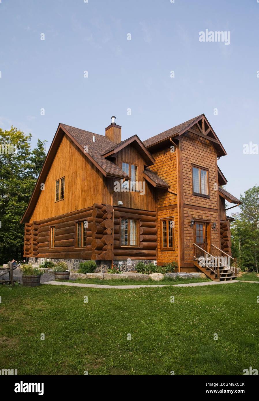 Side and rear view of Scandinavian style log home with vertical wood