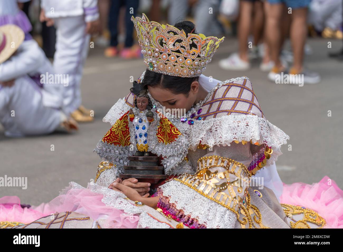 Sinulog Festival Street dancer holding a Santo Nino figurine during the 2023 Grande Parade, Cebu City, Philippines Stock Photo