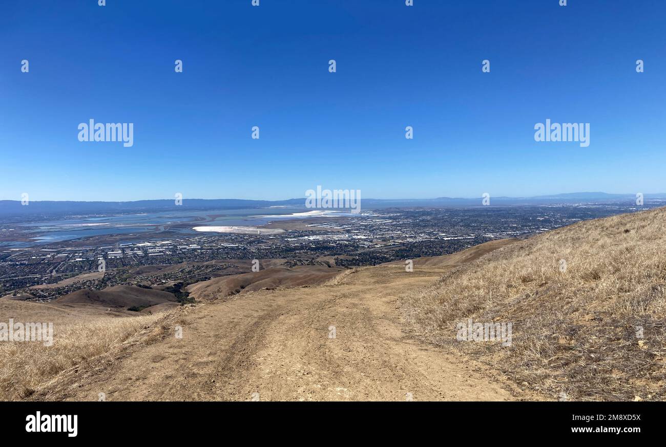 Aerial panoramic view of valley floor and San Francisco Bay from hiking trail during fall season. Stock Photo