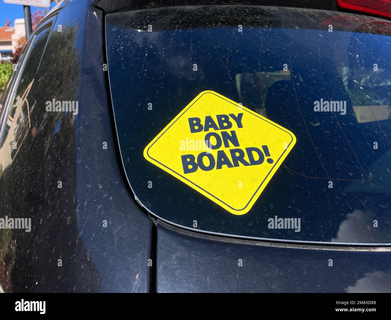 https://c8.alamy.com/comp/2M8XD88/baby-on-board-warning-sign-yellow-bumper-sticker-on-the-car-rear-door-2M8XD88.jpg