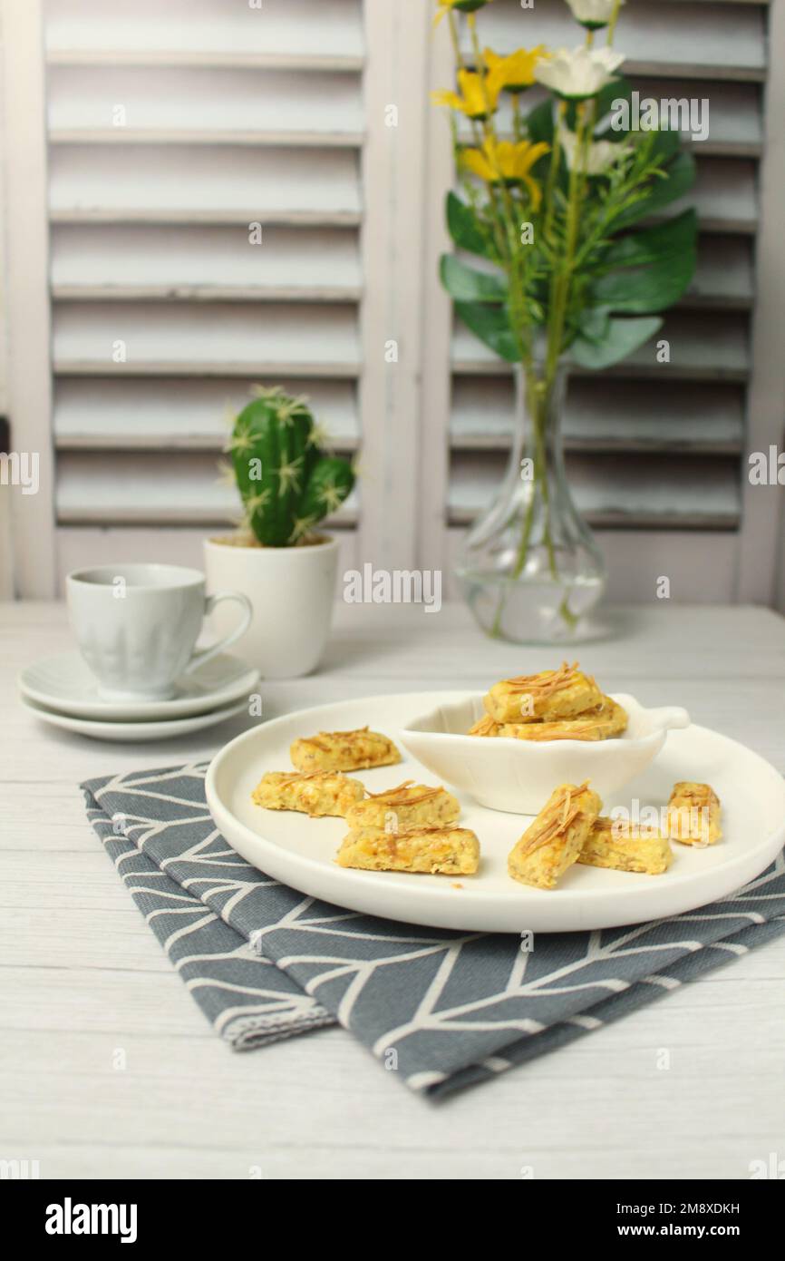 Kastengel or cheese cookies served on a white plate. It is often served as a snack during Eid al-Fitr. Stock Photo