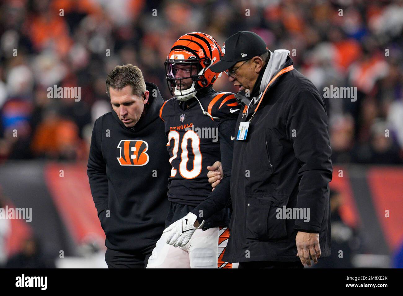 Cincinnati Bengals cornerback Eli Apple is helped off the field after being  injured in the first half of an NFL wild-card playoff football game against  the Baltimore Ravens in Cincinnati, Sunday, Jan.