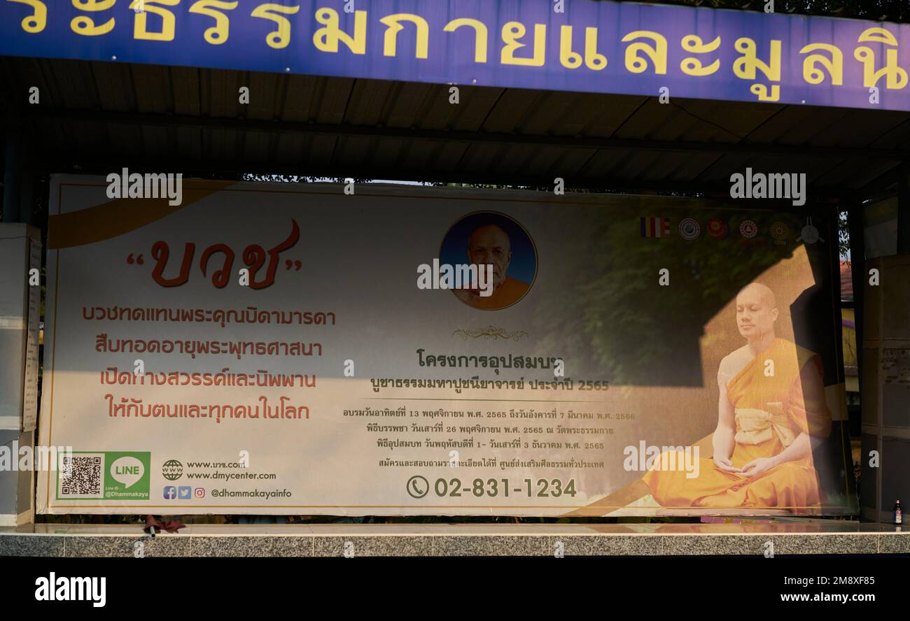 A local bus stop sponsored by a temple, is illuminated in an interesting way by evening sunlight, taken at Pathumthani, Thailand, in January 2023. Stock Photo