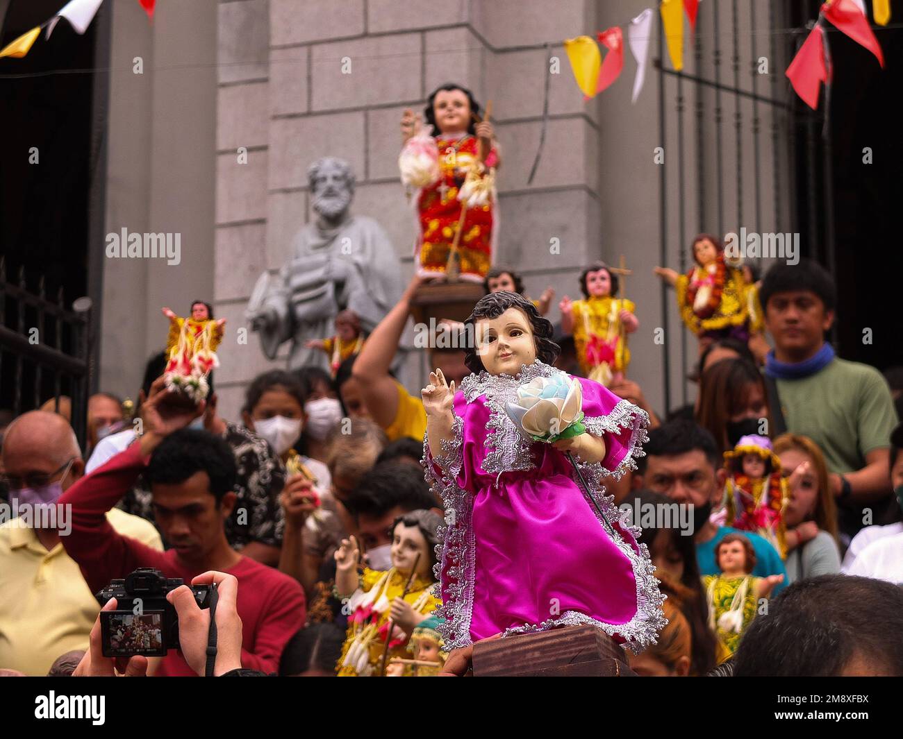 Manila, Philippines. 15th Jan, 2023. Santo Niño replicas raising upward by their owners leaving Tondo Church. Catholic devotees flock to Santo Niño de Tondo Parish also known as Tondo Church in Manila, with their Sto. Niño replicas at home for it's blessing. The country's oldest catholic icon, the Santo Niño or the Roman Catholic title of the child Jesus. Associated with a religious image of the Christ child widely venerated as miraculous by Filipino Catholics. (Photo by Josefiel Rivera/SOPA Images/Sipa USA) Credit: Sipa USA/Alamy Live News Stock Photo