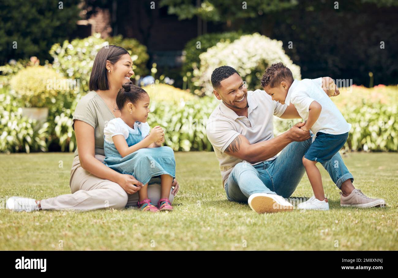 Days like these put everything into perspective. Shotof a happy young family enjoying a fun day out at the park. Stock Photo