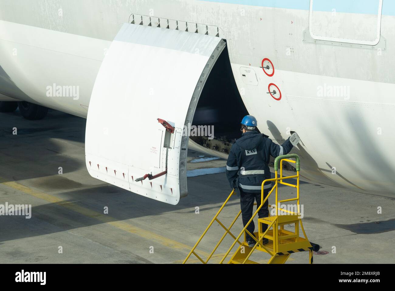 Seoul, Korea. 22nd Dec, 2022. A ramp crew member opens the cargo door hatch ona Korean Air