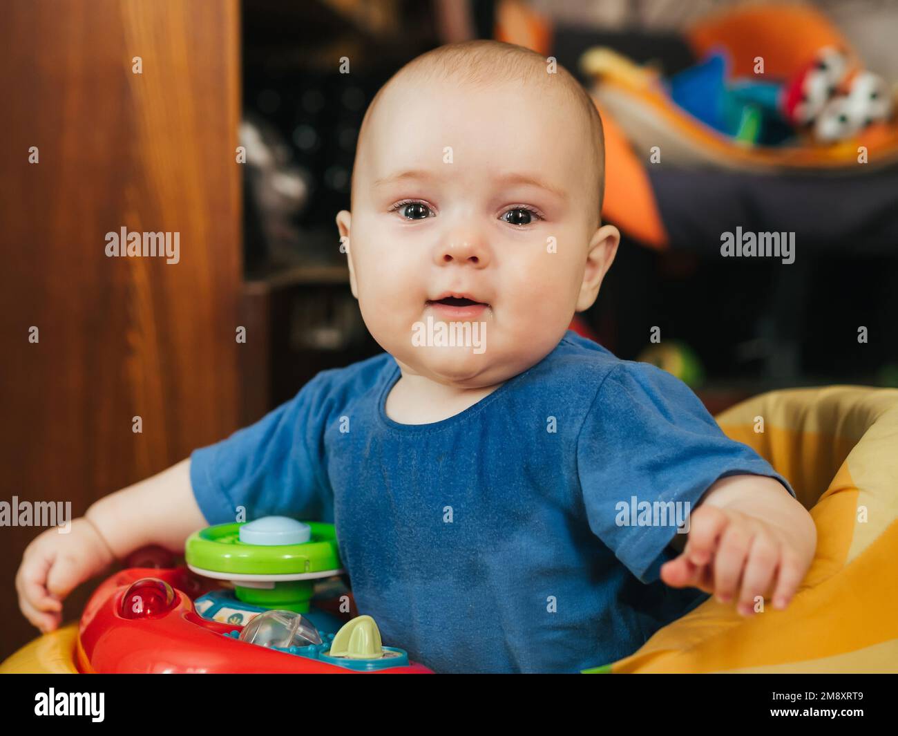 cute happy baby boy in walkers Caucasian looks Stock Photo Alamy