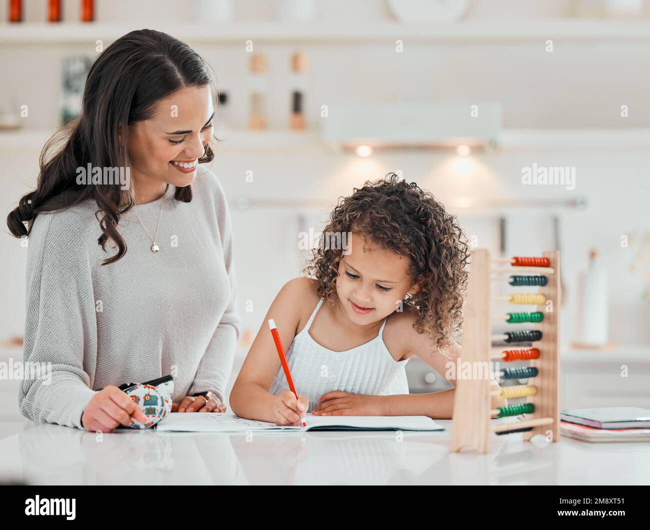 Youre getting there. a young mother helping her daughter with homework at home. Stock Photo