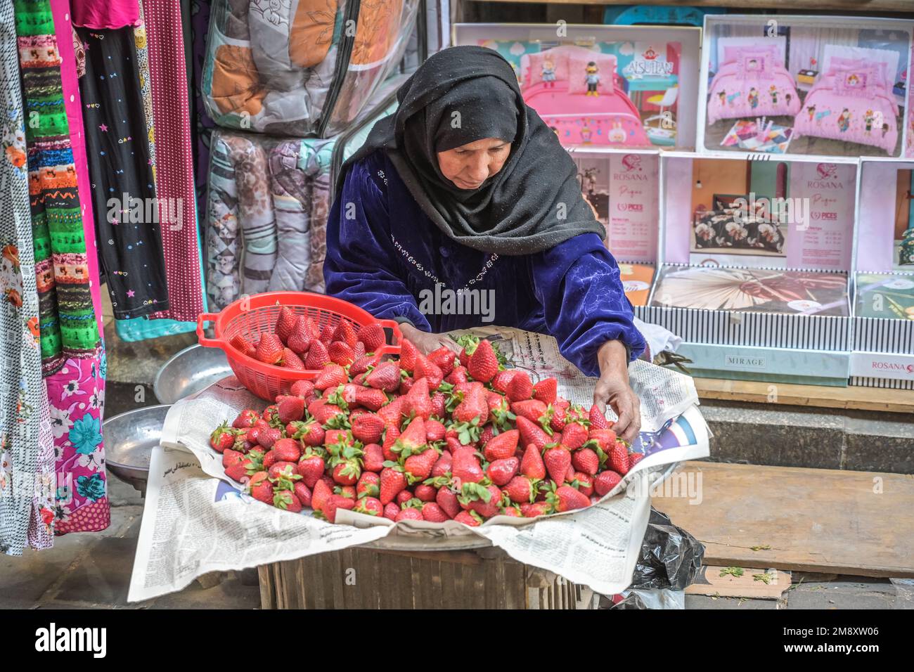 Woman selling fresh strawberries, Khan el-Khalili bazaar, Old City, Cairo, Egypt Stock Photo